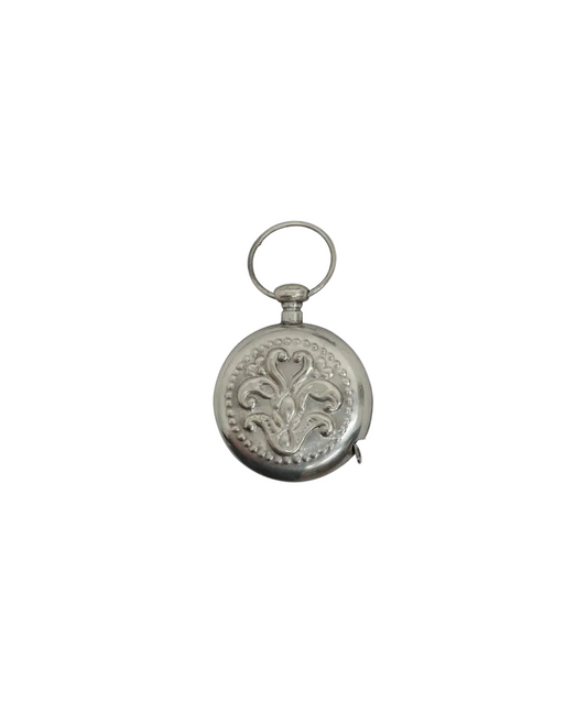 Decorative silver keychain with intricate design on a white background