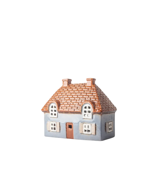 Small model of a house with a tiled roof on a white background