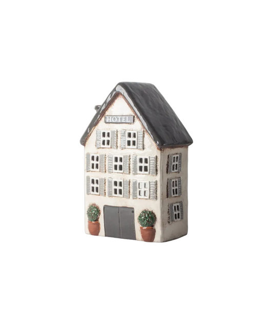Ceramic house-shaped container with 'Hotel' sign on a white background